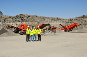 Hamilton Aggregates owners Genia and Edward Hamilton (center) pose with co-owners of their distributor, Crushing Tigers. Pat Doab (left) is managing director, and Brian Costello (right) is sales director.