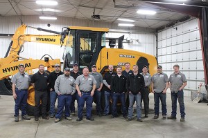 The Rueter’s staff posts by a Hyundai HL940XT wheel loader at the company’s new branch in Albert Lea, Minnesota. Photo courtesy of Hyundai