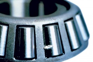 Large particle contamination wedged in the soft cage material can result in grooving. Photo courtesy of The Timken Co.