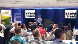 Sean Loughran, director of McCloskey Washing Systems, addresses dealers at the company’s training event.