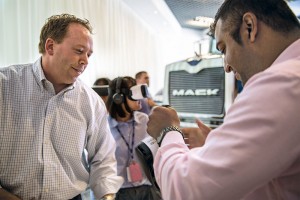 Neil Tolbert, director of marketing communications at Mack Trucks, assists a customer with a VR experience. Photo courtesy of Mack Trucks