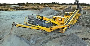Some portable plant users are warming up to diesel-electric hybrids, utilizing the diesel engine to position the machine before bringing in more cost-effective line power. Photo courtesy of Keestrack.