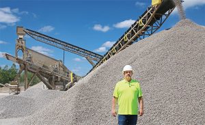 Ronnie Simms, quarry manager at Con-Agg Companies, is pictured in front of the 8-ft. x 20-ft. Vibro King TL portable screening plant. Photo courtesy of Telsmith