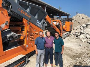 From left: SC Recycling Center supervisor Michael Morais, Rockster CEO Wolfgang Kormann and Titan Enterprises CEO Jack Pereira in front of the R900. Photo courtesy of Rockster