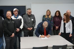 OAIMA’s Pat Jacomet signs an agreement to launch the MACC Tech program at Butler Tech. Photo courtesy of Butler Tech